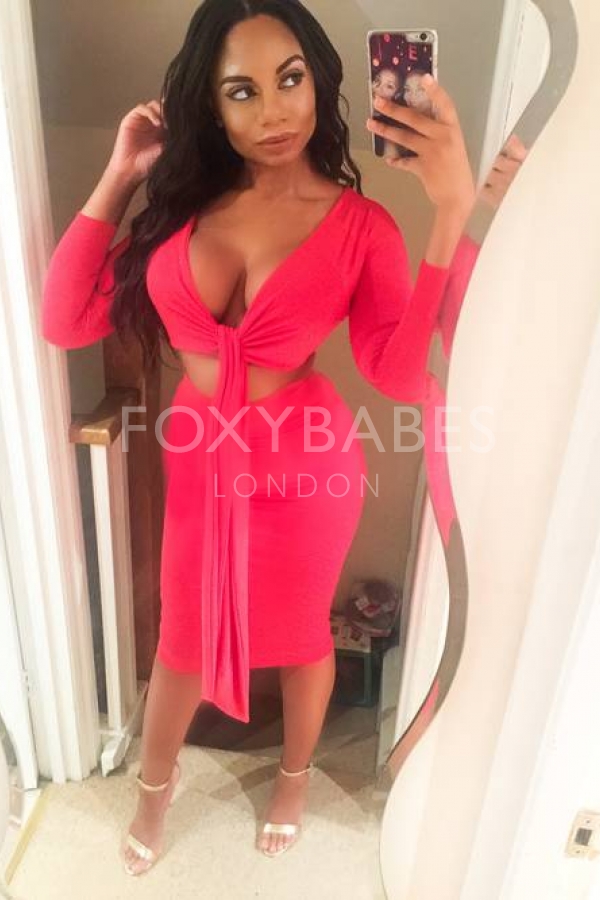 Skye in pink dress taking selfie in mirror 